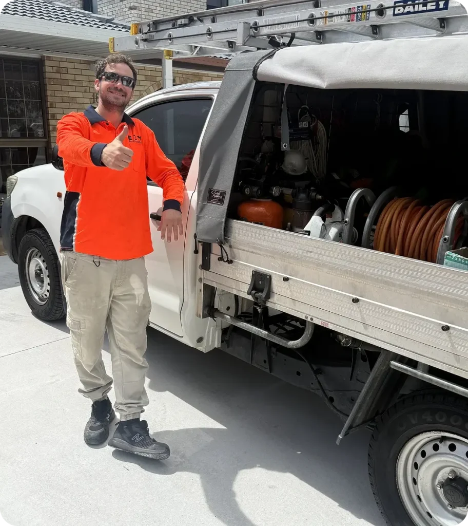 EZY Solar Cleaning technician standing beside a service vehicle and equipment ready for a solar maintenance job